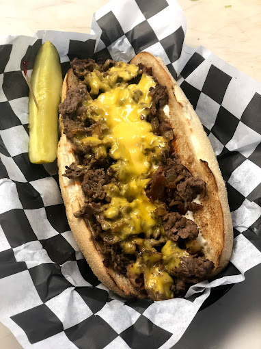 philly cheesesteak with a pickle spear at new york corner deli on topsail island, nc