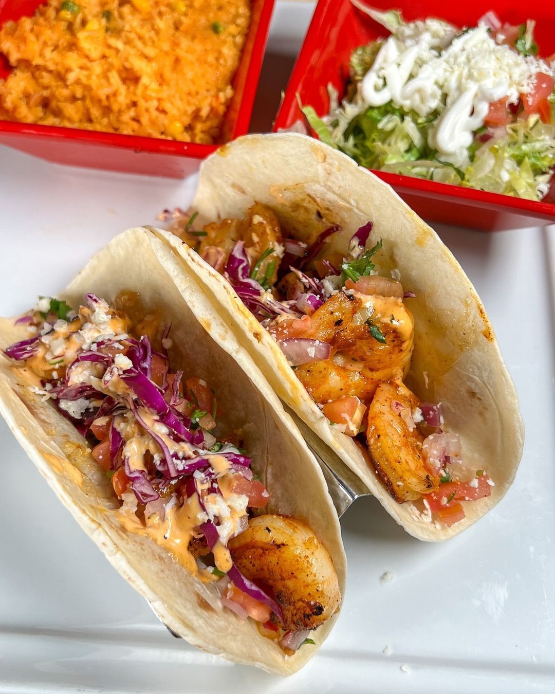 two shrimp tacos topped with slaw at a surf city restaurant